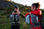 girl and man hiking with aarn balance pockets on side of hill